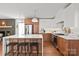 Modern kitchen with a large island, stainless steel appliances, wood cabinets, and hardwood floors at 6100 Rose Valley Dr, Charlotte, NC 28210
