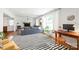 Open-concept living room with hardwood floors, large windows, and a comfortable seating area at 6100 Rose Valley Dr, Charlotte, NC 28210