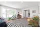 Bright living room featuring a large window, a cozy seating area, and a stylish black and white rug at 6100 Rose Valley Dr, Charlotte, NC 28210