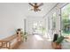 Bright sunroom with tiled floors, multiple windows and a door to the backyard at 6100 Rose Valley Dr, Charlotte, NC 28210