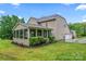 Large backyard featuring a screened porch area, manicured lawn, and lush landscaping at 6312 Crosshall Pl, Waxhaw, NC 28173