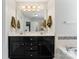 This bathroom features a double sink with a large mirror and decorative lighting at 6312 Crosshall Pl, Waxhaw, NC 28173