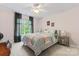 Cozy bedroom featuring light-pink walls, a patterned duvet, and a large window at 6312 Crosshall Pl, Waxhaw, NC 28173
