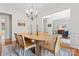Bright dining area with a wooden table, light fixtures, and neutral decor at 6312 Crosshall Pl, Waxhaw, NC 28173