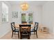 Charming dining area features a round wood table, black chairs, and a stylish pendant light fixture at 6312 Crosshall Pl, Waxhaw, NC 28173
