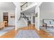 Bright foyer with wood floors, staircase, and classic architectural details at 6312 Crosshall Pl, Waxhaw, NC 28173
