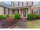 Charming home featuring a covered front porch, brick accents, and manicured landscaping at 6312 Crosshall Pl, Waxhaw, NC 28173
