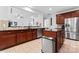 Spacious kitchen features stainless steel appliances, island with granite countertop, and rich wood cabinetry at 6312 Crosshall Pl, Waxhaw, NC 28173