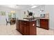 Stylish kitchen with a granite island, stainless steel dishwasher, and an open view to the dining area at 6312 Crosshall Pl, Waxhaw, NC 28173