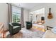 Living area with two chairs, hardwood floors, and ample natural light at 6312 Crosshall Pl, Waxhaw, NC 28173