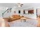 Open-concept living space with a brown sectional and bright natural light at 6312 Crosshall Pl, Waxhaw, NC 28173