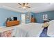 This main bedroom features elegant tray ceilings, blue walls, and carpet flooring at 6312 Crosshall Pl, Waxhaw, NC 28173