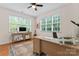Bright home office featuring large windows, wooden desk, and decorative rug at 6312 Crosshall Pl, Waxhaw, NC 28173