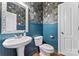 Stylish powder room showcasing elegant wallpaper, wainscoting and decorative mirror at 6312 Crosshall Pl, Waxhaw, NC 28173