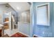 Well-lit bathroom featuring a shower with frosted glass, toilet, and hardwood floors at 6420 Conifer Cir, Indian Trail, NC 28079