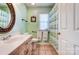 Bathroom with green walls, a sink with vanity, toilet, and a shower with a curtain at 6420 Conifer Cir, Indian Trail, NC 28079