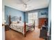 Bedroom with a floral comforter, carpeted floor, ceiling fan, and natural light at 6420 Conifer Cir, Indian Trail, NC 28079