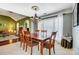 Elegant dining room with hardwood table, chandelier, and large window for natural light at 6420 Conifer Cir, Indian Trail, NC 28079
