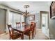 Dining room with chandelier, large window with blinds and view to the next room at 6420 Conifer Cir, Indian Trail, NC 28079