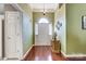 Bright foyer featuring hardwood floors, a chandelier, and a view of the front door with sidelights at 6420 Conifer Cir, Indian Trail, NC 28079