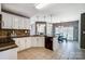 The kitchen with a dining area has tiled floors and white cabinetry with an island at 6420 Conifer Cir, Indian Trail, NC 28079