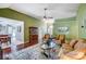 Open concept living room with hardwood flooring, elegant furnishings, and seamless flow to the dining area at 6420 Conifer Cir, Indian Trail, NC 28079