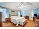 Spacious primary bedroom with light blue walls, carpeted floors and a ceiling fan at 6420 Conifer Cir, Indian Trail, NC 28079