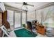Office space in sunroom with a fan, large windows and a view to the backyard at 6420 Conifer Cir, Indian Trail, NC 28079