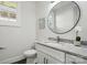 Bright bathroom with white cabinets, granite countertop, and modern fixtures at 68 Cabarrus W Ave, Concord, NC 28025