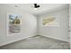 Empty bedroom with neutral paint, carpet, ceiling fan and natural light from two windows at 68 Cabarrus W Ave, Concord, NC 28025