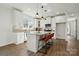 Modern kitchen featuring white cabinets, stainless steel appliances, and a center island with seating at 68 Cabarrus W Ave, Concord, NC 28025