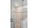 Walk-in shower with glass door, decorative tile, and stone flooring at 68 Cabarrus W Ave, Concord, NC 28025