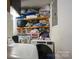Functional laundry area featuring a washer, dryer, and shelving for convenient storage at 6800 Deanwood Pl, Charlotte, NC 28217
