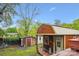 Backyard view of a wooden shed with a cozy porch, providing extra space for storage or hobbies at 6800 Deanwood Pl, Charlotte, NC 28217