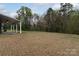 Spacious backyard featuring a covered patio, perfect for outdoor relaxation and entertaining at 7217 Cedarfield Rd, Charlotte, NC 28227