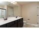 Bathroom features a double sink with a large vanity, a toilet, and large mirror at 7217 Cedarfield Rd, Charlotte, NC 28227