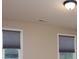 Bedroom with neutral paint, and two windows, and dark gray shades at 7217 Cedarfield Rd, Charlotte, NC 28227