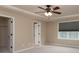 Spacious bedroom with a ceiling fan, ensuite, and large window at 7217 Cedarfield Rd, Charlotte, NC 28227