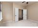 Bright bedroom featuring neutral walls, carpet flooring, and a double-door entry at 7217 Cedarfield Rd, Charlotte, NC 28227
