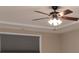 A lighted ceiling fan and crown molding detail in a neutral room at 7217 Cedarfield Rd, Charlotte, NC 28227