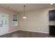 Dining room featuring wood flooring, a pendant light, and neutral walls at 7217 Cedarfield Rd, Charlotte, NC 28227