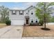 Charming two-story home with a well-manicured lawn and attached two-car garage at 7217 Cedarfield Rd, Charlotte, NC 28227