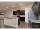 Modern kitchen featuring dark cabinets, granite countertops, stainless steel appliances, and wood flooring at 7217 Cedarfield Rd, Charlotte, NC 28227