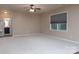 Spacious living room with neutral walls, ceiling fan, carpet flooring, and a window at 7217 Cedarfield Rd, Charlotte, NC 28227