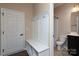 Hallway with a mudroom bench with coat hooks and access to a powder room at 7217 Cedarfield Rd, Charlotte, NC 28227