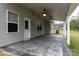 Covered patio with ceiling fans and a door to the backyard at 7217 Cedarfield Rd, Charlotte, NC 28227