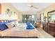 Comfortable bedroom with neutral walls, a fan, and access to balcony at 9025 J M Keynes Dr # 69, Charlotte, NC 28262