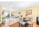 Open concept dining area with wood floors, neutral walls, and elegant lighting fixture at 9025 J M Keynes Dr # 69, Charlotte, NC 28262
