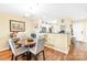 Cozy dining area with hardwood floors, a round table, and views into the kitchen at 9025 J M Keynes Dr # 69, Charlotte, NC 28262