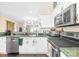 Bright kitchen features modern stainless steel appliances, white cabinets and green countertops at 9025 J M Keynes Dr # 69, Charlotte, NC 28262